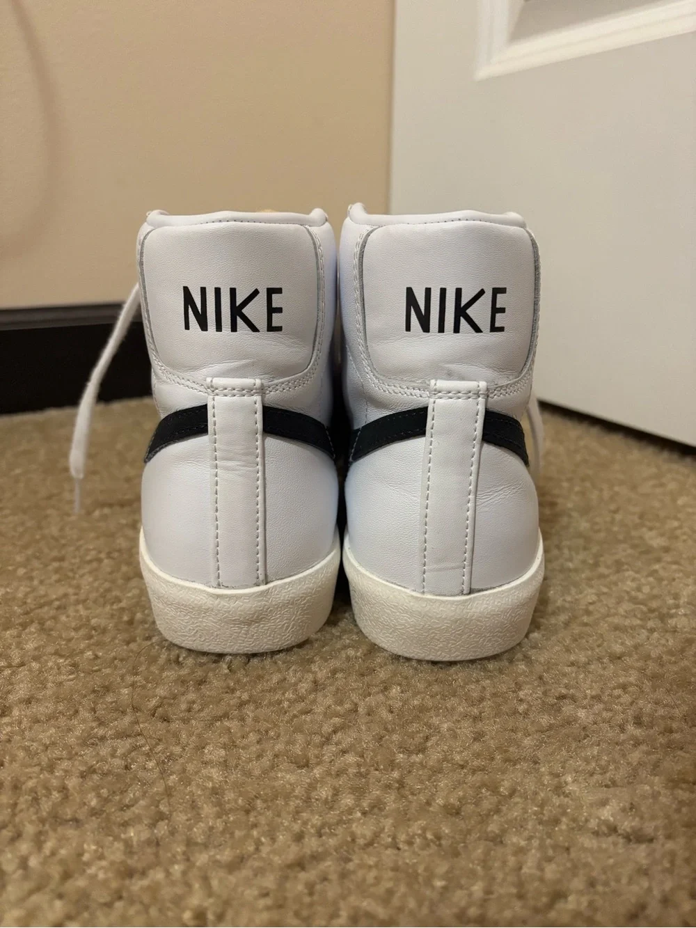 Nike White High-Top Sneakers with Black Swoosh and Yellow Tongue